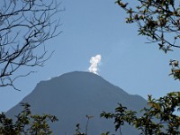 The volcano in mid mornnf with steam rising from the main crater